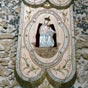 En l'glise: Bannire  la gloire de Notre Dame de Buclose pose sur un mur en garluche...
