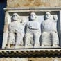 Ce bas-relief montrerait au travers dune reprsentation ce qui est important et dsirable : trois livres sont prsents ici, trois livres qui permettraient daccder  la connaissance spirituelle de ceux qui les portent. Lartiste a pu vouloir exprimer l'importance de ces livres en mettant en avant ou en valeur ceux qui les portent.  La connaissance que lintelligence se doit de saisir, pourrait tre dfinie comme tant celle de ceux qui, les pieds nus, sont assis et par-l mme trnent, en tant aurols.  Dans une reprsentation spirituelle,  tre assis , du verbe seoir, cest tre tabli. La connaissance spirituelle stablit toujours dans la connaissance de 