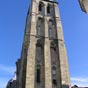 La tour de l'horloge tout comme la tour Charlemagne  sont les seuls  vestiges de l'ancienne basilique mdivale  (IXe sicle-1802). L'glise fut incendie par les Normands le 8 novembre 853, puis  nouveau le 30 juin 903,  la suite de quoi le sanctuaire fut entour d'une enceinte fortifie, distincte de celle de Tours, acheve en 918. Il y eut un grand incendie accidentel en 994, ce qui entrana une reconstruction, sous l'impulsion d'Herv de Buzanais, alors trsorier de Saint-Martin, et une nouvelle conscration en 1014. Un sinistre eut encore lieu en 1096, et on procda  un grand remaniement de l'difice entre 1175 et 1180 : c'tait alors une tape importante sur la Via Turonensis du plerinage de Saint-Jacques-de-Compostelle. 