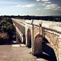 Montpellier : L'aqueduc des Arceaux, de son vrai nom l'aqueduc Saint-Clment, construit au XVIIIe sicle par l'ingnieur Henri Pitot de Launay, est l'un des plus beaux monuments de la ville. Cet difice, largement inspir du pont du Gard, a permis l'arrive d'eau potable depuis la source du Boulidou, puis plus tard celle du Lez, situes  Saint-Clment-de-Rivire.  sa construction, il permet d'apporter 25 litres d'eau par seconde  la ville de Montpellier. Il fut dtruit dans sa quasi-totalit  la fin du XXe sicle,  la suite de l'implantation d'une usine souterraine qui permit de produire en toute saison 2 000 litres d'eau pour la ville.