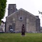 L'glise Sainte-Croix. Une tradition veut que la premire pierre de Sainte-Croix ait t pose en 1070 par l'vque Amat, lgat du pape rformateur Grgoire VII. Son achvement aprs 1090, du temps de Gaston IV le Crois est plus certain. Son plan est celui d'une basilique bndictine avec juste ce qui faut de transept pour baucher la forme d'une croix, une haute nef et une haute abside, des bas-cts et des absidioles recuits,  l'extrieur, une tour fortifie au dessus du bas-ct nord, un portail en plein cintre aux voussures dcales en coquille, avec deux chapiteaux brods reprsentant l'un la Damnation (un pcheur enlev par des monstres ails) l'autre la Vie Eternelle (une colombe buvant la calice tendu par une main).